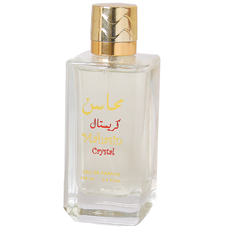 A 100 ml bottle of Mahesto Crystal Eau de Parfum with a gold cap and gold/red lettering on a clear glass bottle, shown against a plain white background.